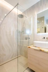 a bathroom with a glass shower and a sink at Brand new home in the center of the Old Town in Klaipėda