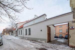 an office building with a garage on a snowy street at Brand new home in the center of the Old Town in Klaipėda