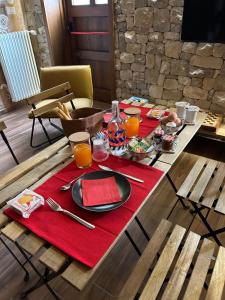 a table with a plate of food and orange juice at Relais 5 Sensi WELLNESS & SPA in Bagnoli Irpino