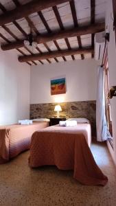 a hotel room with two beds in a room at Posada San Gabriel in Colonia del Sacramento