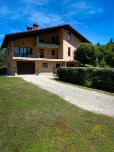 a large house with a driveway in front of it at Apartment David in Tršće