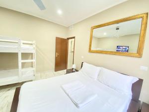a bedroom with a white bed and a mirror at Moderno, tra metropolitana Milano e Aeroporto di Linate in Linate