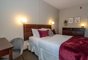Postel nebo postele na pokoji v ubytování Hotel Dorion
