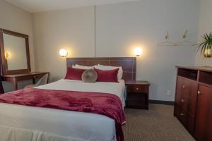 Postel nebo postele na pokoji v ubytování Hotel Dorion