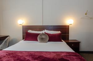 Postel nebo postele na pokoji v ubytování Hotel Dorion