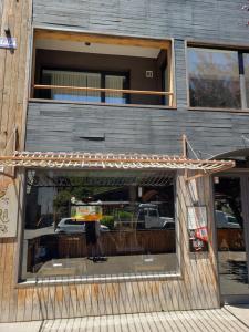 awning over the entrance of a building at Departamento Cameron - Salepatagonia in San Martín de los Andes