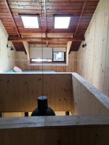 a room with a bed and a chandelier at Departamento Cameron - Salepatagonia in San Martín de los Andes