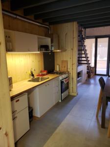 a kitchen with a sink and a stove top oven at Departamento Cameron - Salepatagonia in San Martín de los Andes
