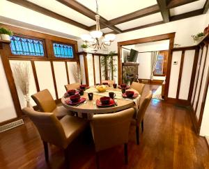 a dining room with a wooden table and chairs at The House Hotel Elmwood in Lakewood