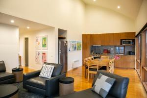a living room with a table and chairs and a kitchen at Frueauf Village in Falls Creek