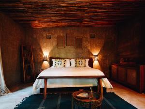a bedroom with a bed in a room at Nomade Tulum in Tulum