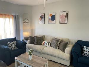 a living room with a couch and two blue couches at Cozy Stylish Townhome in Davenport
