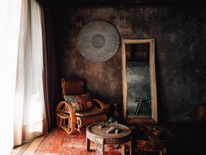 a room with a chair and a table and a mirror at Nomade Tulum in Tulum