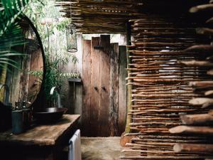 a room with a wall made of wood at Nomade Tulum in Tulum