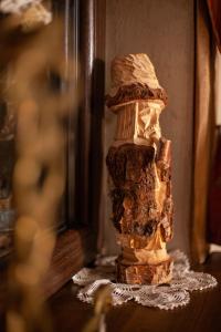 a stone pillar sitting on a table next to a mirror at BIESIADA in Korbielów +26 photos