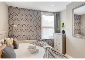 a bedroom with a large bed and a window at Chic & Radiant Retreat in Harringay Ladder in London