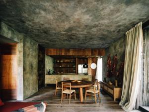 a dining room with a table and chairs at Nomade Tulum in Tulum