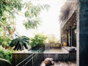 a person sitting on a porch of a building at Nomade Tulum in Tulum