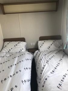 dwa łóżka z napisem na nich w sypialni w obiekcie Lunas chill pad w Edynburgu