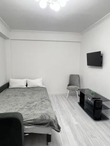 En eller flere senge i et værelse på Luxury Aparts