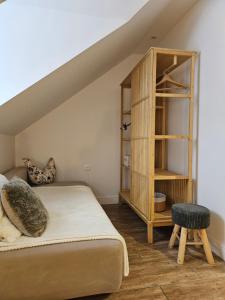 a bedroom with a bed and a book shelf at Dworek Góra i Kura in Brenna