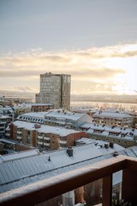 a view of a city with snow covered roofs at Guestly Homes - 1BR Harbor View Suite in Piteå