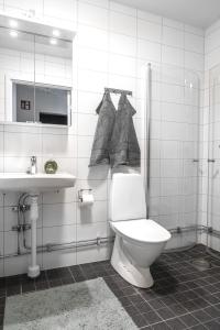 a bathroom with a toilet and a sink at Guestly Homes - 1BR Harbor View Suite in Piteå