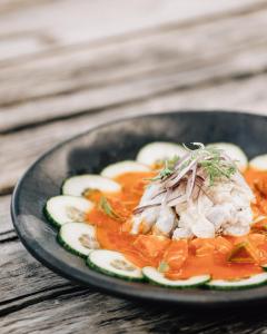 a plate of food on a wooden table at Nomade Tulum in Tulum