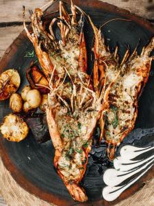 a plate of food with shrimp and other foods at Nomade Tulum in Tulum