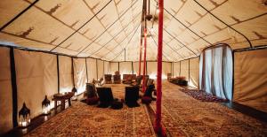 a large tent with a couch and chairs in it at Nomade Tulum in Tulum