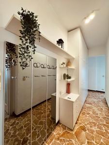 a room with white cabinets and a potted plant at Casa vacanze LA NINA in Varazze