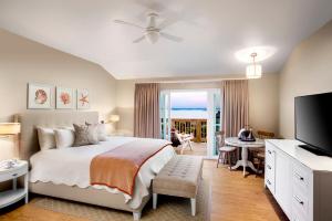 a bedroom with a bed and a flat screen tv at Sanderling Resort Outer Banks in Duck