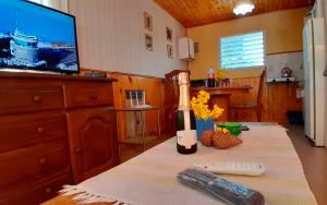 une cuisine avec une table et une bouteille de vin ainsi qu'une télévision dans l'établissement Alas de Mirlos, à Potrerillos