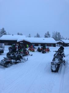 a group of snow vehicles parked in the snow at Joy Stugan Näsfjället in Sörsjön