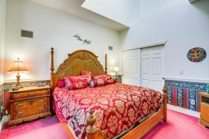 a bedroom with a large bed with a red bedspread at Ocean Shores Condo Rental with View - Walk to Beach! in Ocean Shores