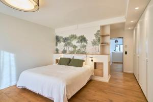 a white bedroom with a bed and a fireplace at Villa Sabaou Feng Shui Biarritz Spa Piscine in Biarritz