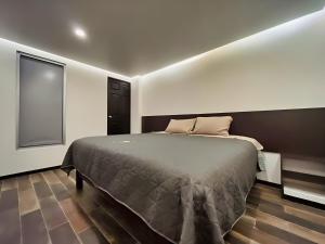 a bedroom with a large bed in a room at Jovis Hotel - Lujo Cultural in Villa Aldama