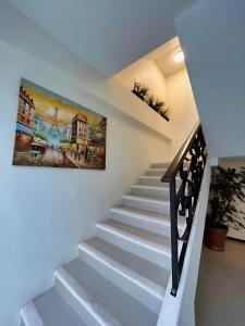 a staircase in a house with a painting on the wall at Jovis Hotel - Lujo Cultural in Villa Aldama