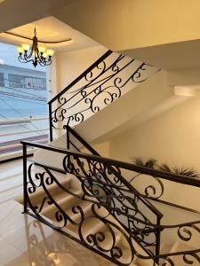a staircase with a black wrought iron railing at Jovis Hotel - Lujo Cultural in Villa Aldama