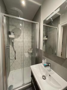 a bathroom with a shower and a sink and a shower at London Heathrow Airport Apartment Voyager House Terminal 12345 - EV electric and Parking available in New Bedfont +19 photos