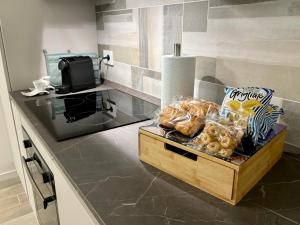 eine Küchentheke mit einer Schachtel Brot und Snacks in der Unterkunft Modern-House • Fiera Milano (MiCo) • City Life in Mailand