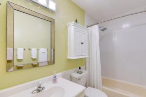 a bathroom with a sink and a toilet and a mirror at Anchorage Vacation Rental Near Coastal Trail! in Anchorage +16 photos