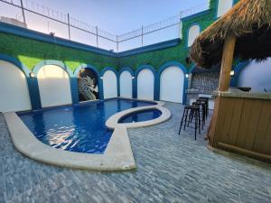 a pool with a letter in the middle of a building at Casa Ostra con alberca privada in Mazatlán