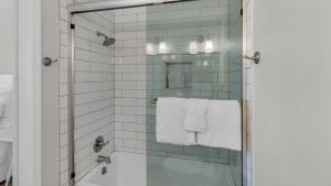a bathroom with a glass shower with white towels at Blue Nine 5 in Panama City Beach +83 photos
