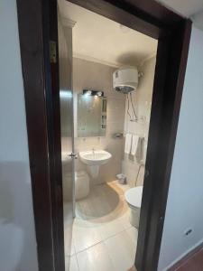 a bathroom with a toilet and a sink at Porto Sokhna Pyramids Apartments in Ain Sokhna