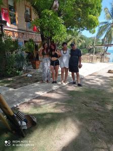 a group of people standing in front of a building at HOSTAL BELLEZA TROPICAL in Moñitos