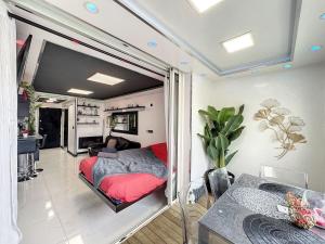 a bedroom with a bed and a living room at C12 Deluxe in Cap d'Agde