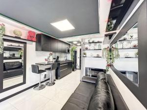 a kitchen and living room with a couch and a counter at C12 Deluxe in Cap d'Agde