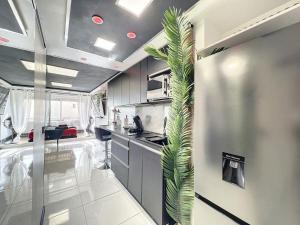 a kitchen with a plant in the middle of it at C12 Deluxe in Cap d'Agde