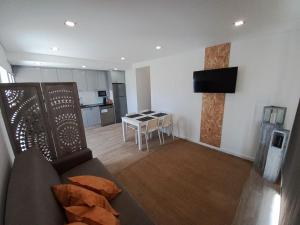 a living room with a couch and a table at Terraços da Serra in Painho